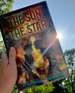 The Sun and the Star, a book that shows the silhouettes of two boys holding hands before a bright flame. 